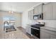 Modern kitchen features stainless steel appliances, granite countertops, and gray cabinets at 3226 Belleville Ridge Rd, Elizabeth, CO 80107