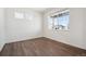 Bright living room with beautiful hardwood floors and a large window allowing for natural light at 3226 Belleville Ridge Rd, Elizabeth, CO 80107