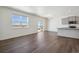 Open living room and kitchen area, features hardwood floors, lots of windows and granite countertops at 3226 Belleville Ridge Rd, Elizabeth, CO 80107