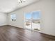 Sunlit living room featuring a sliding glass door that opens to an outdoor space at 3226 Belleville Ridge Rd, Elizabeth, CO 80107