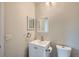 Bright bathroom featuring a white vanity, toilet, and tiled shower at 8643 Carr Loop, Westminster, CO 80005