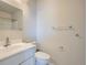 A bright bathroom features a white vanity and shower with a mirror at 8643 Carr Loop, Westminster, CO 80005