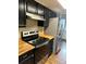 Modern kitchen with stainless steel appliances and wood countertops at 8643 Carr Loop, Westminster, CO 80005