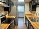 Well-lit kitchen with stainless steel appliances and black cabinetry at 8643 Carr Loop, Westminster, CO 80005