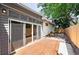 Charming back deck with sliding glass doors, leading to a gravel-covered yard with a wooden fence at 3131 S Washington St, Englewood, CO 80113