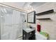 Classic bathroom with tiled walls, shower, and a vanity with black accents at 3131 S Washington St, Englewood, CO 80113