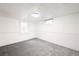 Clean, white bedroom with carpeted flooring and ample natural light from two windows at 3131 S Washington St, Englewood, CO 80113