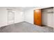 Bright bedroom with carpeted flooring, closet, and a view into a secondary room at 3131 S Washington St, Englewood, CO 80113