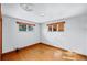 Empty bedroom with hardwood floors and windows providing natural light at 3131 S Washington St, Englewood, CO 80113