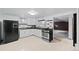 Bright kitchen with stainless steel appliances, white cabinets, and light flooring in basement at 3131 S Washington St, Englewood, CO 80113