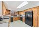 Functional kitchen with wooden cabinets, modern appliances, and tile flooring at 3131 S Washington St, Englewood, CO 80113