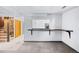 Cozy living room with carpeted floor and black marble bar and staircase at 3131 S Washington St, Englewood, CO 80113