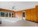 Large sun room with sliding glass doors, wood paneling, and a ceiling fan at 3131 S Washington St, Englewood, CO 80113