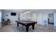 Finished basement with a pool table, bar area, modern lighting fixtures, and an open doorway to a bedroom at 24963 E Phillips Pl, Aurora, CO 80016