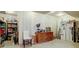 Unfinished basement featuring shelving, work bench with drill press and peg board tool storage at 24963 E Phillips Pl, Aurora, CO 80016