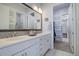 Bright en-suite bathroom with a double sink vanity, a large mirror, and ample lighting at 24963 E Phillips Pl, Aurora, CO 80016