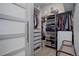 Walk-in closet featuring built-in shelving, drawers, and ample hanging space for clothes and storage at 24963 E Phillips Pl, Aurora, CO 80016
