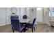 Cozy dining room with modern table and stylish blue upholstered chairs at 24963 E Phillips Pl, Aurora, CO 80016