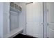 Functional entryway with built-in bench, coat hooks, and storage shelves near closet at 24963 E Phillips Pl, Aurora, CO 80016