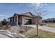 Charming stone-accented home with well-maintained landscaping and a two-car garage at 24963 E Phillips Pl, Aurora, CO 80016