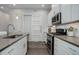 Modern kitchen featuring stainless steel appliances and white cabinets with stylish hardware at 24963 E Phillips Pl, Aurora, CO 80016
