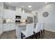 Well-appointed kitchen with modern appliances, island seating, and ample cabinet space at 24963 E Phillips Pl, Aurora, CO 80016