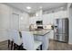 Bright, modern kitchen with stainless steel appliances and island seating at 24963 E Phillips Pl, Aurora, CO 80016