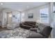 Bright living room with a leather sofa, recliner, and lots of natural light from large windows at 24963 E Phillips Pl, Aurora, CO 80016