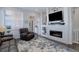 Cozy living room featuring a modern fireplace, mounted TV, and comfortable seating at 24963 E Phillips Pl, Aurora, CO 80016