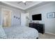 Spacious main bedroom with a TV, ceiling fan, and comfortable king-size bed at 24963 E Phillips Pl, Aurora, CO 80016