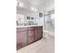 Bathroom vanity with brown cabinets, white countertop, and glass-enclosed shower at 1585 Hecla Way # 304, Louisville, CO 80027