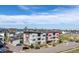 Modern three-story condominium building with clean lines and a community in the background at 1585 Hecla Way # 304, Louisville, CO 80027