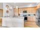 Bright kitchen with stainless steel appliances, a quartz countertop island, and plenty of cabinet space at 1585 Hecla Way # 304, Louisville, CO 80027