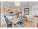 Stylish kitchen and dining area featuring stainless steel appliances, light wood cabinets, and hardwood floors at 1585 Hecla Way # 304, Louisville, CO 80027