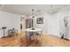 Bright dining area features hardwood floors, a modern light fixture, and stylish decor at 410 Acoma St # Brownstone 3, Denver, CO 80204