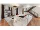 Spacious living room featuring a white couch, hardwood floors, and a modern staircase at 410 Acoma St # Brownstone 3, Denver, CO 80204