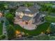Expansive home with a stone patio, covered deck, water feature, mature trees and a fenced yard at 27290 E Nova Cir, Aurora, CO 80016
