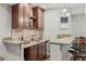 Elegant bar area featuring custom cabinetry, granite countertops, and a convenient sink for entertaining at 27290 E Nova Cir, Aurora, CO 80016