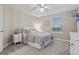 Bright bedroom with neutral tones, includes a queen bed, and a street view at 27290 E Nova Cir, Aurora, CO 80016