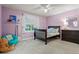 Cozy bedroom features a twin bed, comfortable beanbag chair, and soft natural lighting at 27290 E Nova Cir, Aurora, CO 80016