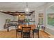 Cozy dining area features a hardwood floor, fireplace, wood beamed ceiling, and an outdoor view at 27290 E Nova Cir, Aurora, CO 80016