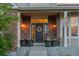 Inviting front porch with brick accents, potted flowers, and a charming entrance. Address 27290 at 27290 E Nova Cir, Aurora, CO 80016