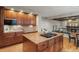 Kitchen island with granite countertops and built-in cooktop, featuring hardwood flooring at 27290 E Nova Cir, Aurora, CO 80016