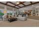 Spacious open floorplan featuring a stone fireplace, vaulted ceiling, and large windows at 27290 E Nova Cir, Aurora, CO 80016