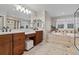 Bright main bathroom featuring double vanity sinks, granite countertops, and a large tub next to a shower at 27290 E Nova Cir, Aurora, CO 80016