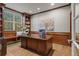 Home office with custom woodwork, built-in bookshelves, and a large window for ample natural light at 27290 E Nova Cir, Aurora, CO 80016
