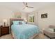 Comfortable bedroom with a blue comforter, wood nightstand, and an accent chair at 11816 Zenobia Loop, Westminster, CO 80031