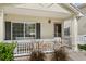 Inviting front porch area with white railings, decorative plants, and a cozy bench at 11816 Zenobia Loop, Westminster, CO 80031