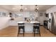 Modern kitchen with white shaker cabinets, island, stainless steel appliances at 1946 Rosemary St, Denver, CO 80220