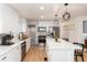 Modern kitchen with white shaker cabinets, island, stainless steel appliances at 1946 Rosemary St, Denver, CO 80220